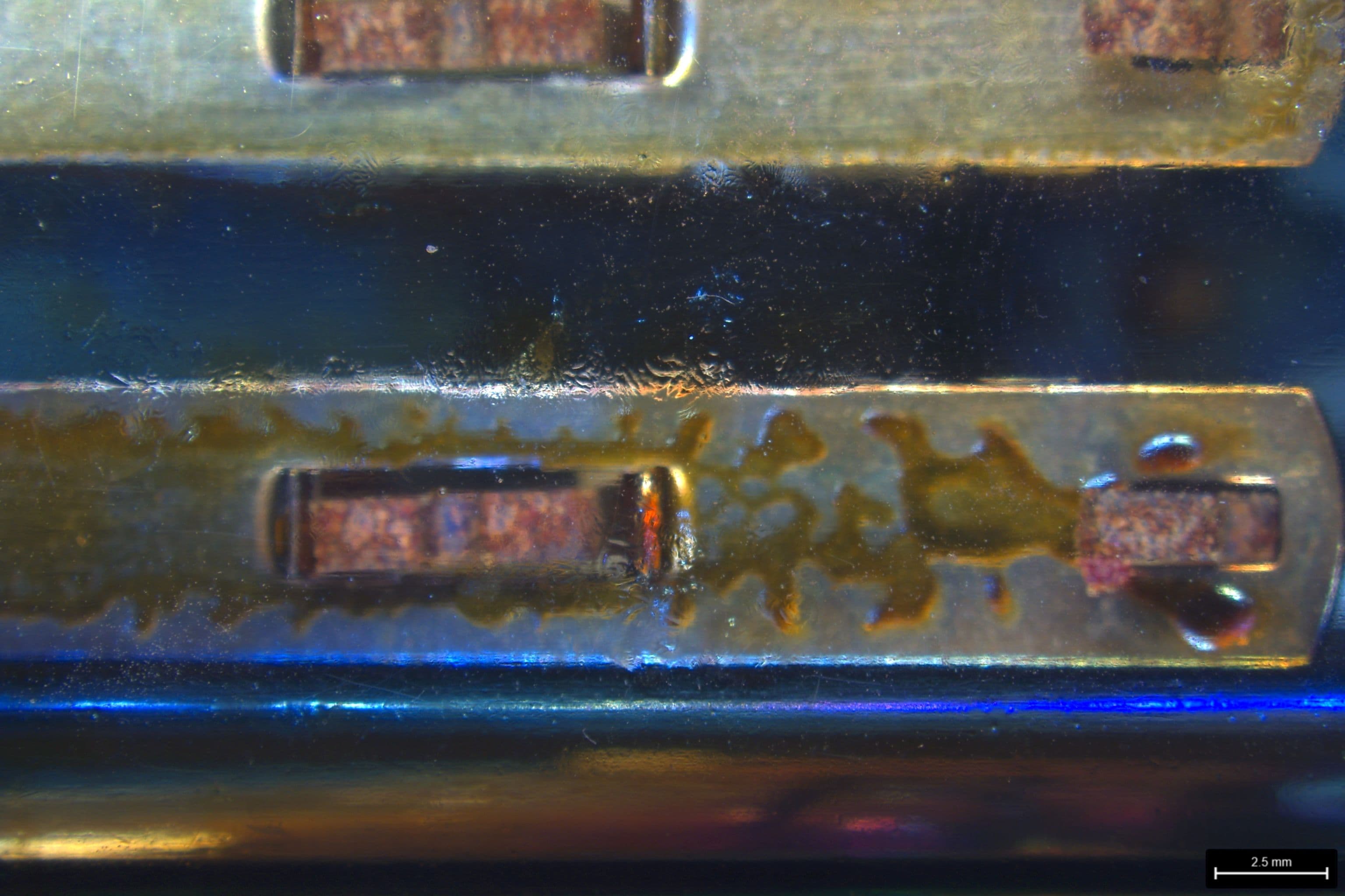 Oily residue viewed on the inside surface of the PC housing.
