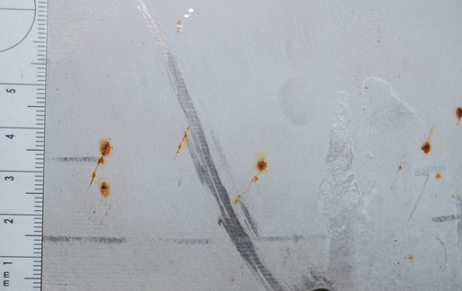 Outer surface of a stainless steel component showing corrosion staining highlighting the cracks