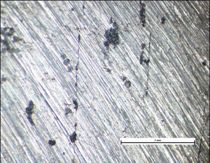Internal surface of the component shown above showing straight SCC and patches of crevice corrosion