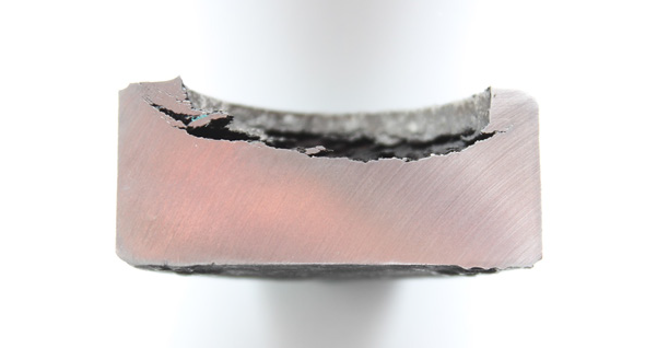 Section through the bolt head showing the concave path of crack propagation